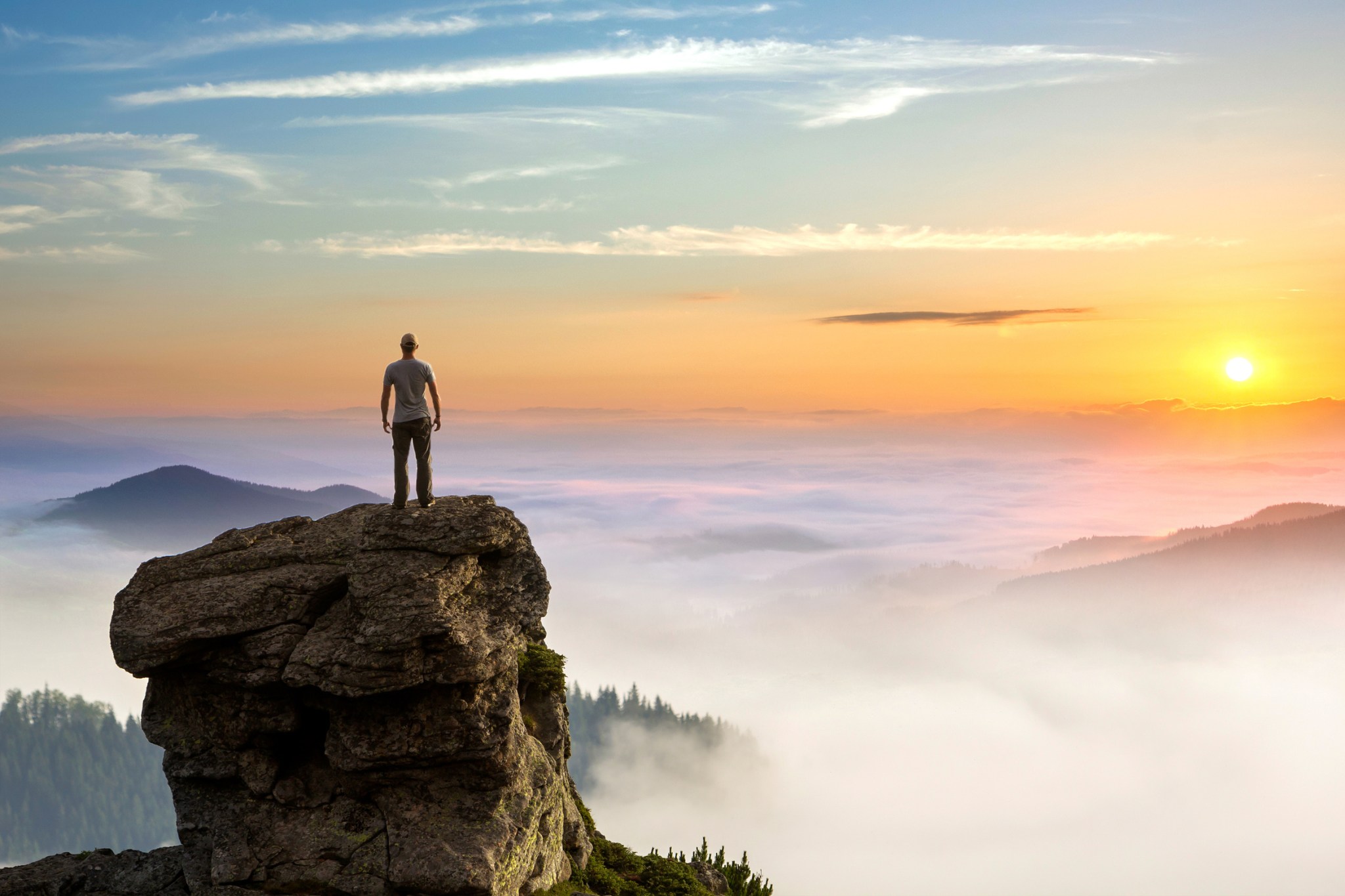 Hiker watching the sunrise from a trail