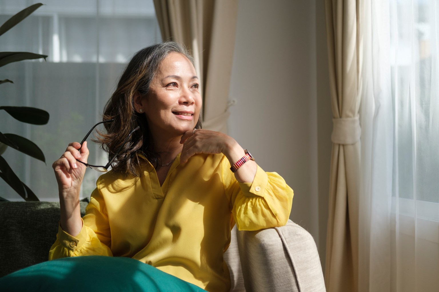 Woman sitting calmly on a sofa